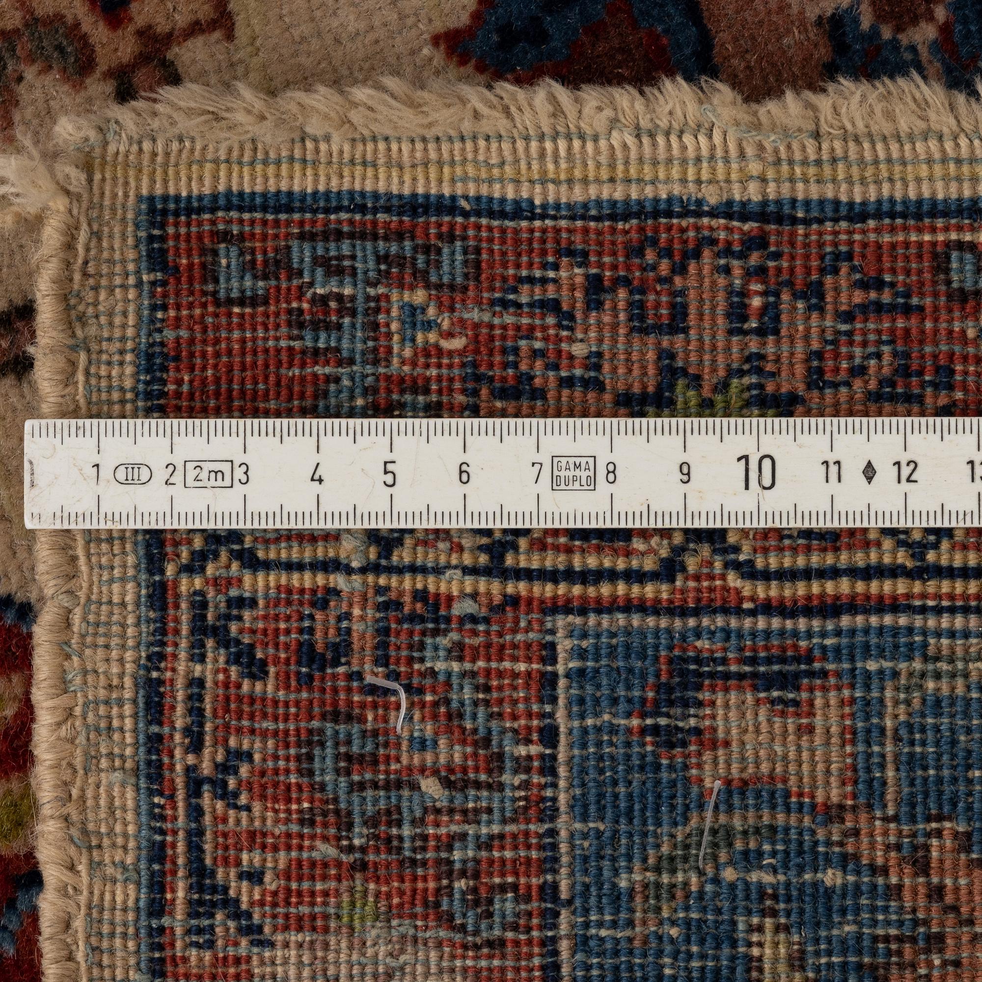 A semi-antique Tabriz ‘Zir Khaki' carpet, ca 366 x 251 cm.