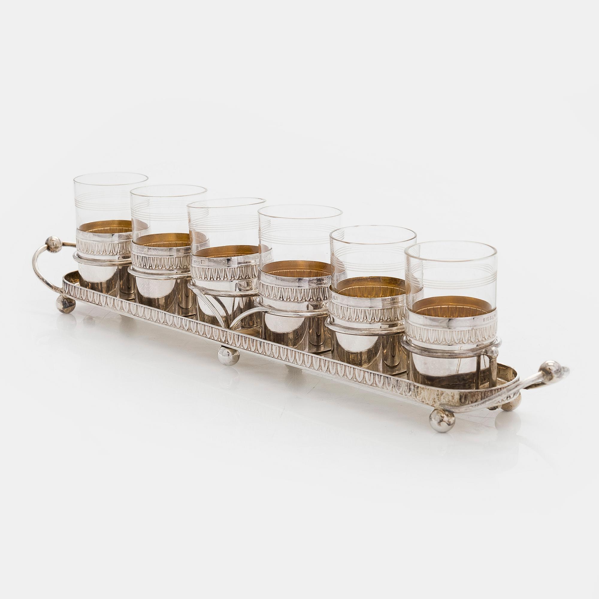 A set of six shot glasses with a tray in original fitted box, silver and glass, likely Norway 1910s.