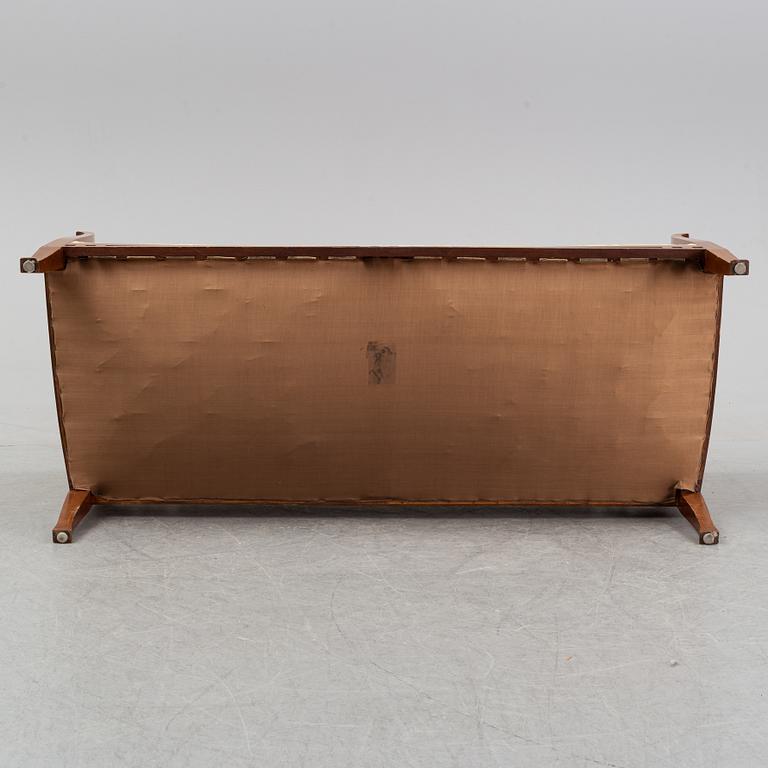 A mahogany sofa, with two armchairs and a round table, early 20th Century.