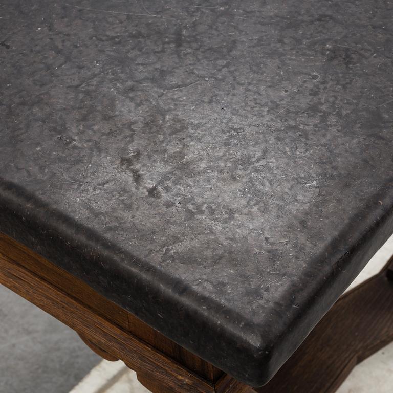 A 19th Century Baroque style table with a stone top.