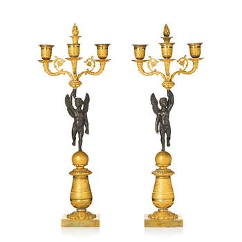 149. A pair of Empire three light ormolu and patinated bronze candelabra.