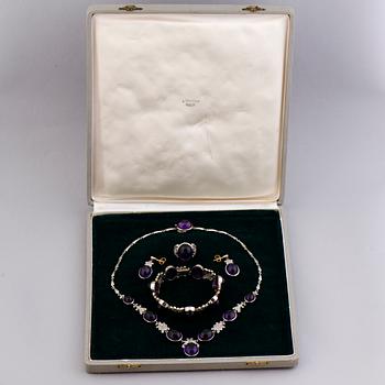 A NECKLACE, BRACELET, EARRINGS and RING, amethysts, diamnonds, 18K white gold and palladium. A. Tillander, 1970s.