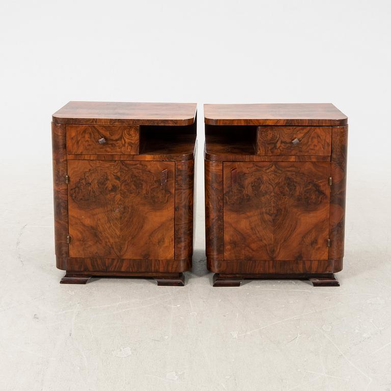 A pair of Art Deco walnut bedside tables.
