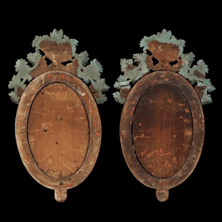 A pair of Swedish Empire two-light mirror girandoles.