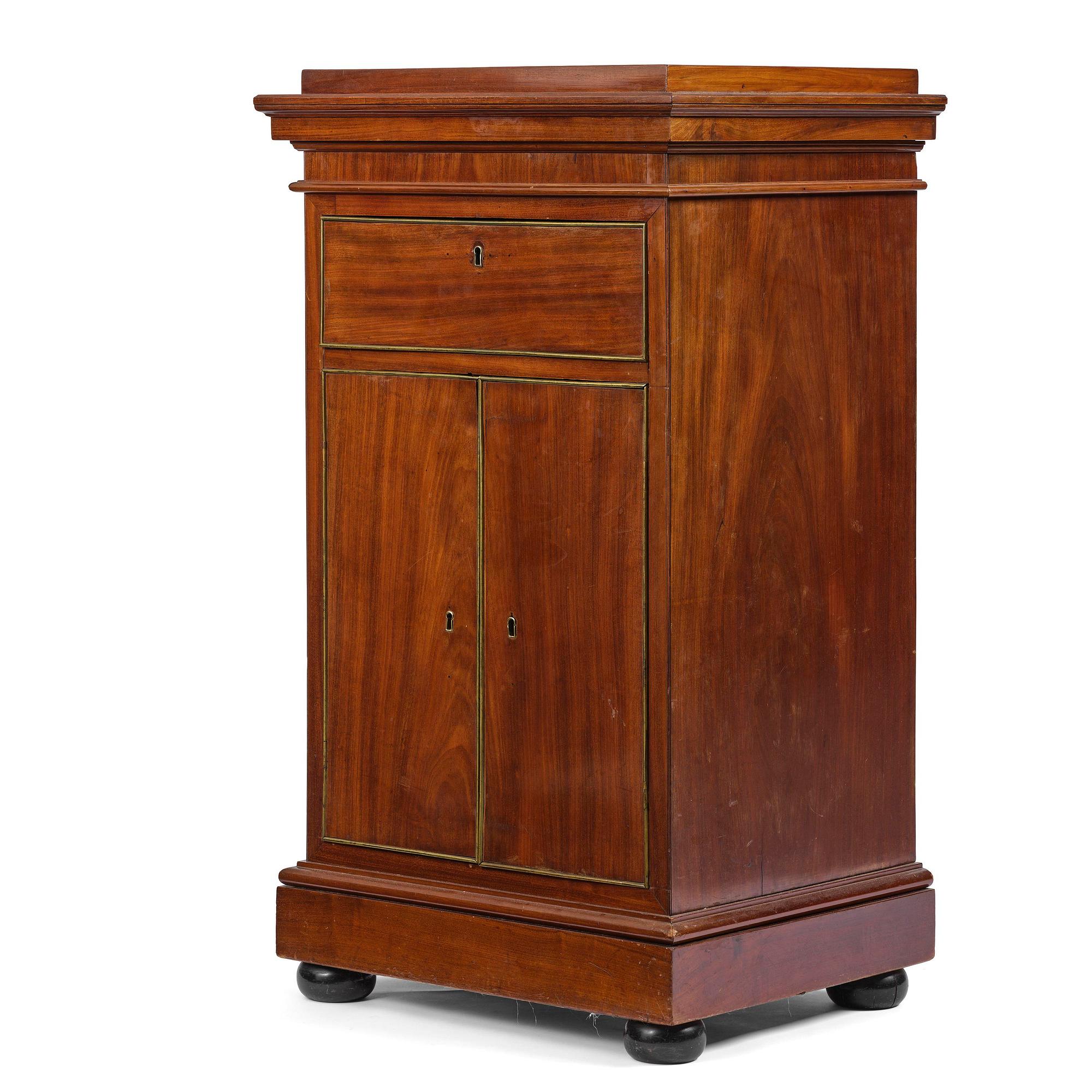 A late Gustavian mahogany column-cabinet, Stockholm, circa 1800.