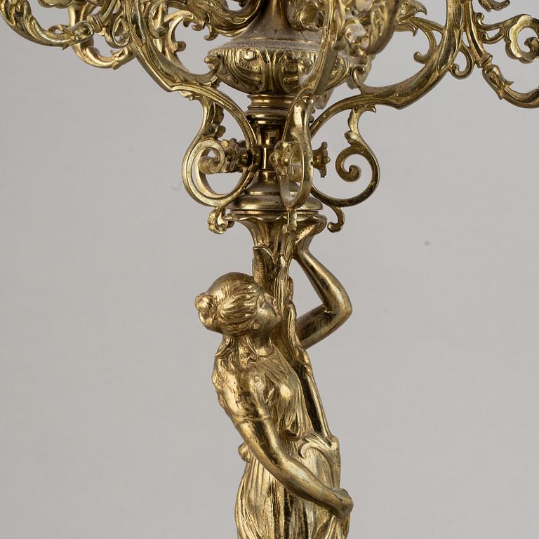 A pair of late 19th century brass candelabra for six candles.