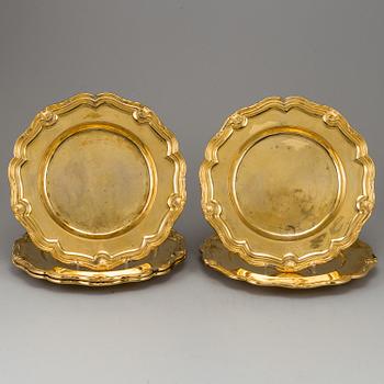 A German set of twelve 19th century silver-gilt plates, mark of Hossauer, Berlin. Rokoko-style.