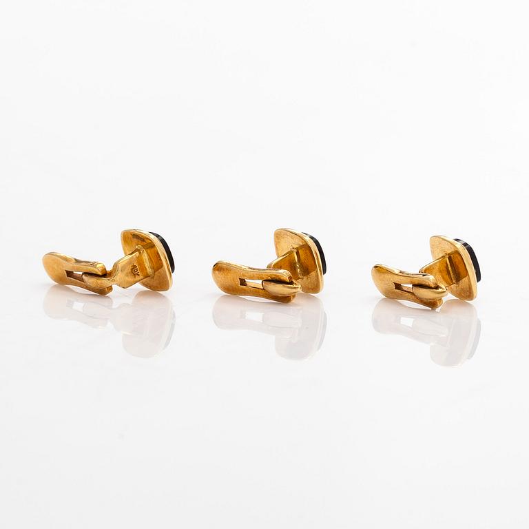 A pair of cufflinks and three shirt buttons,  18K gold and onyx.