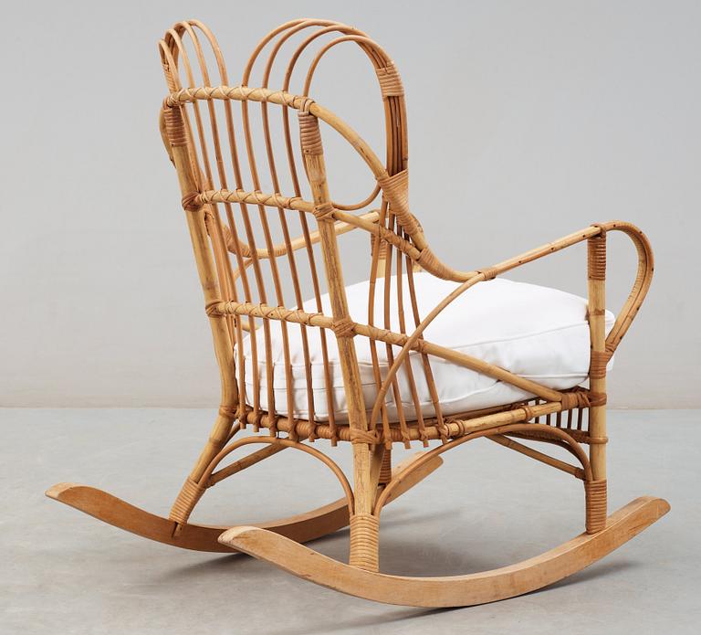 A Josef Frank ratten and beech rocking chair, Svenskt Tenn, model 1077, 1940's-50's.