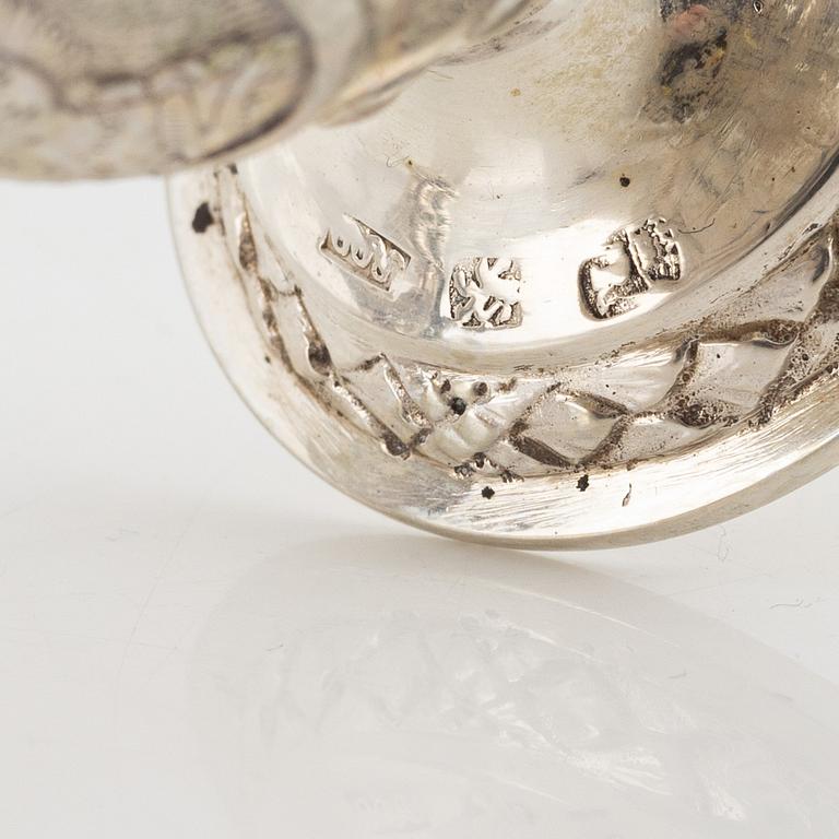 Three Silver Shakers and a Beaker.