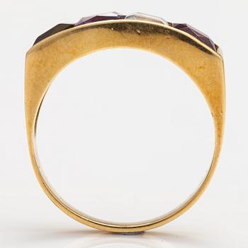 An 18K gold ring with an amethyst, garnet, topaz and peridote.