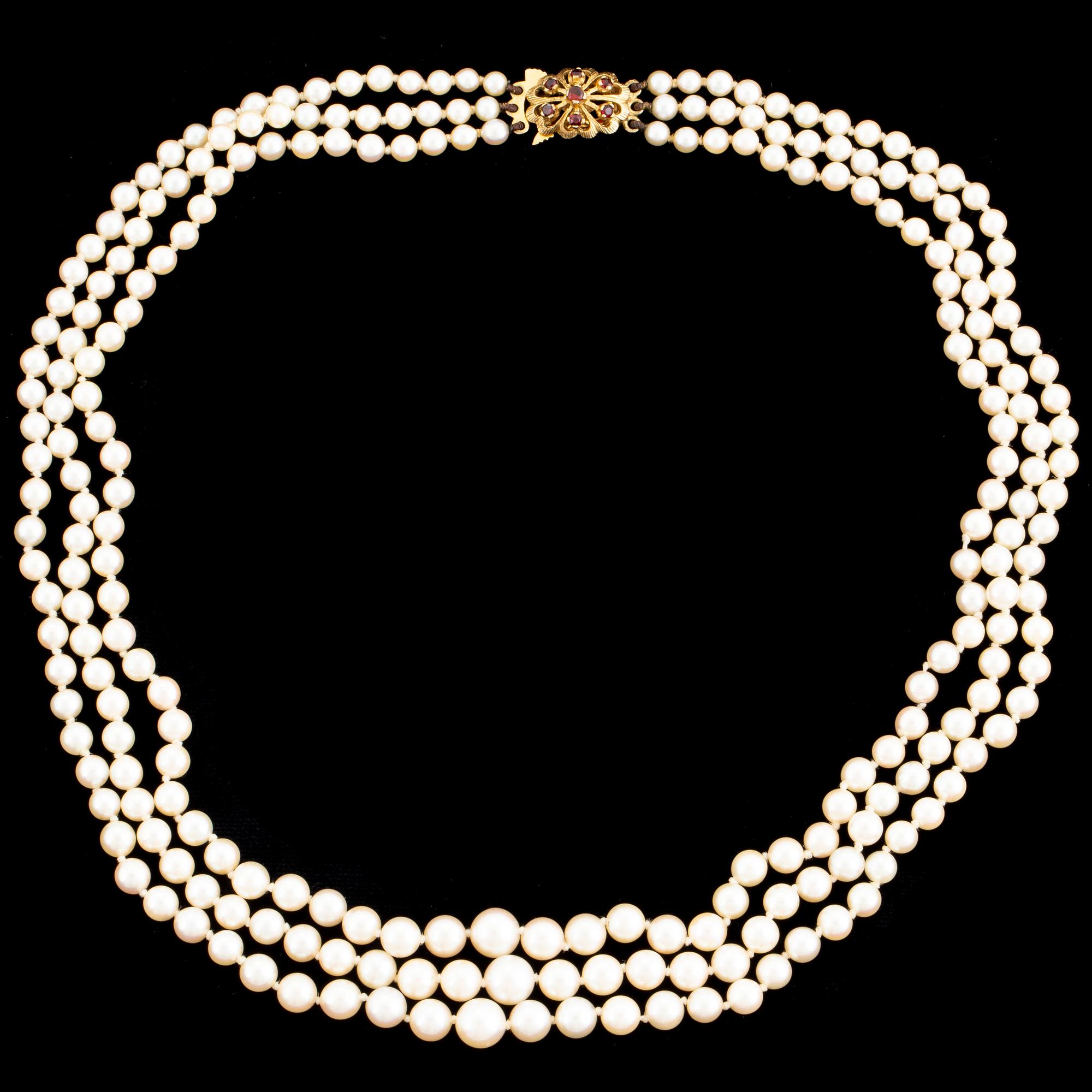 A three strand cultured pearl necklace.
