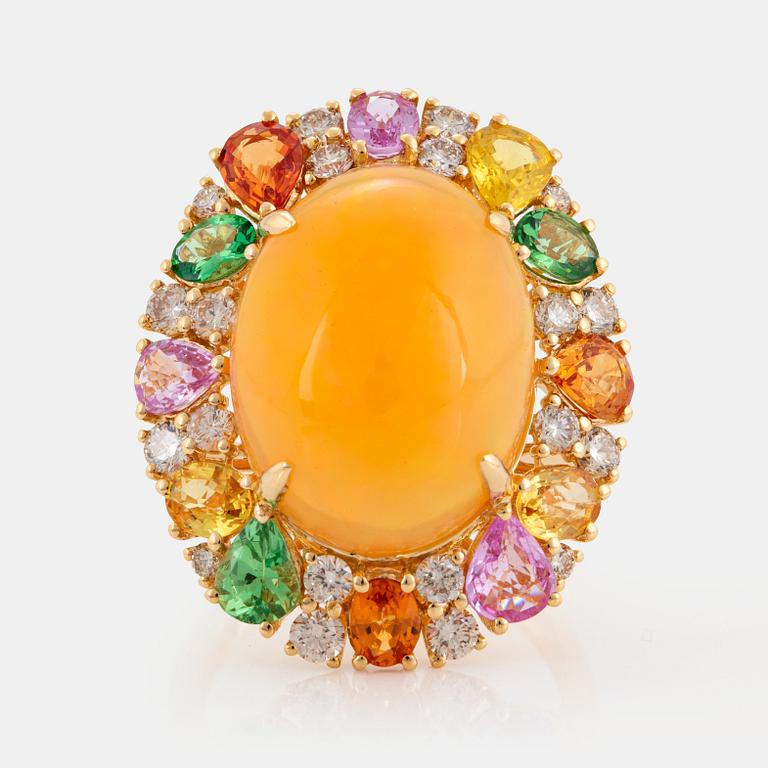 An 18K gold ring set with an opal, round brilliant-cut diamonds.