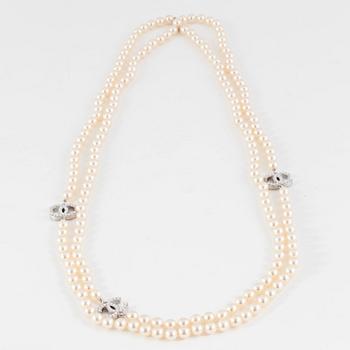 CHANEL, a decorative pearl necklace.