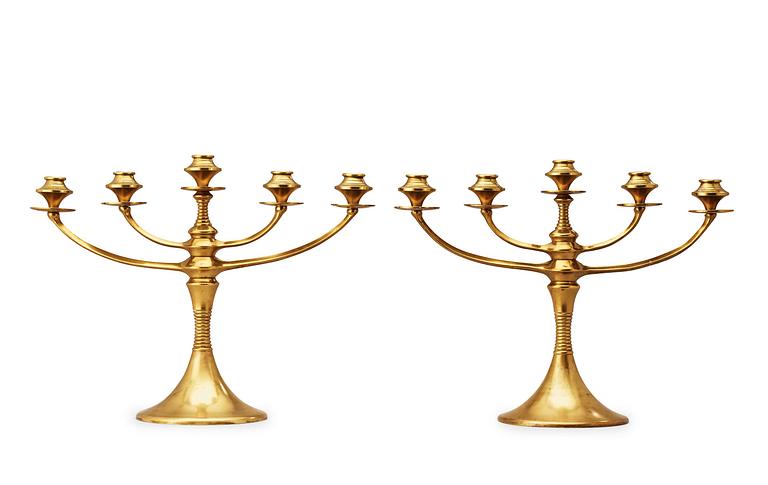 A pair of brass candelabra attributed to Bruno Paul, Germany, early 20th Century.