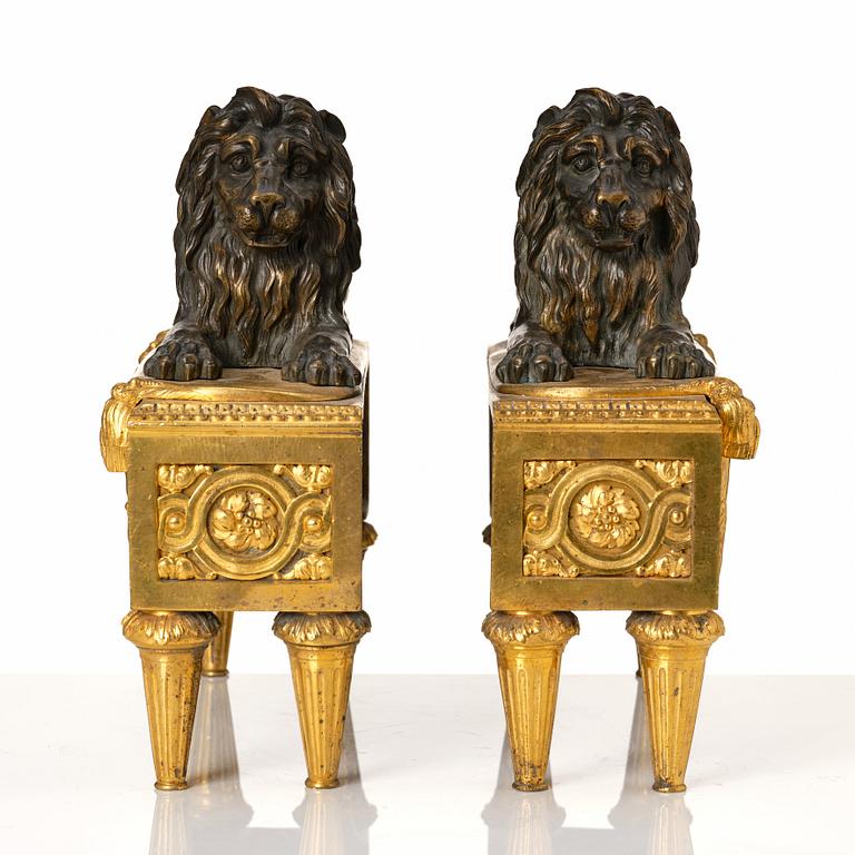 A pair of Louis XVI gilt and patinated bronze chenets.