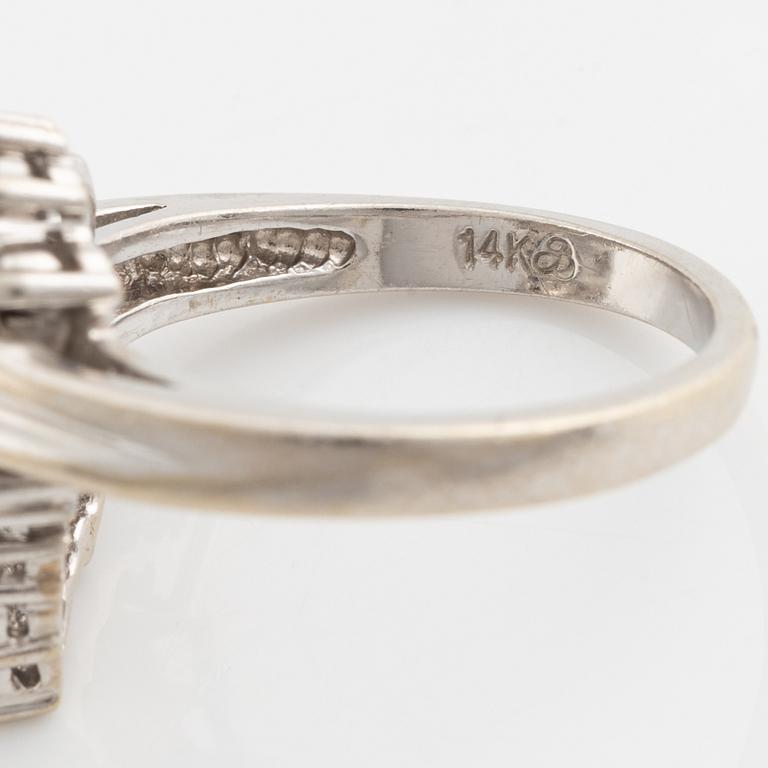 A 14K gold ring set with round brilliant-cut diamonds.