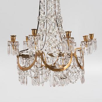 A Louis XVI gilt-brass and cut glass nine-light chandelier, circa 1800.