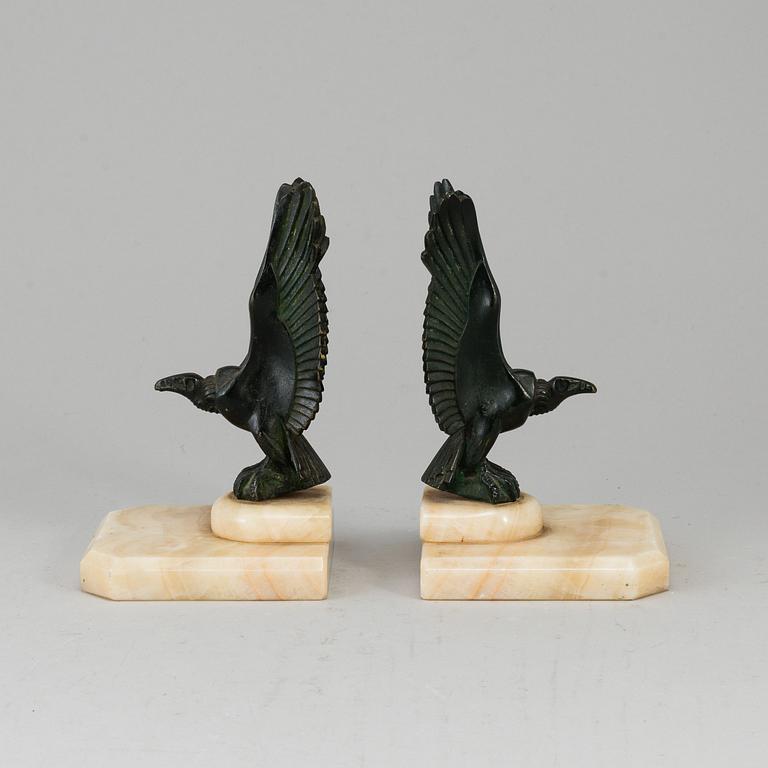 A pair of art déco marble and bronze book ends, 1930s.