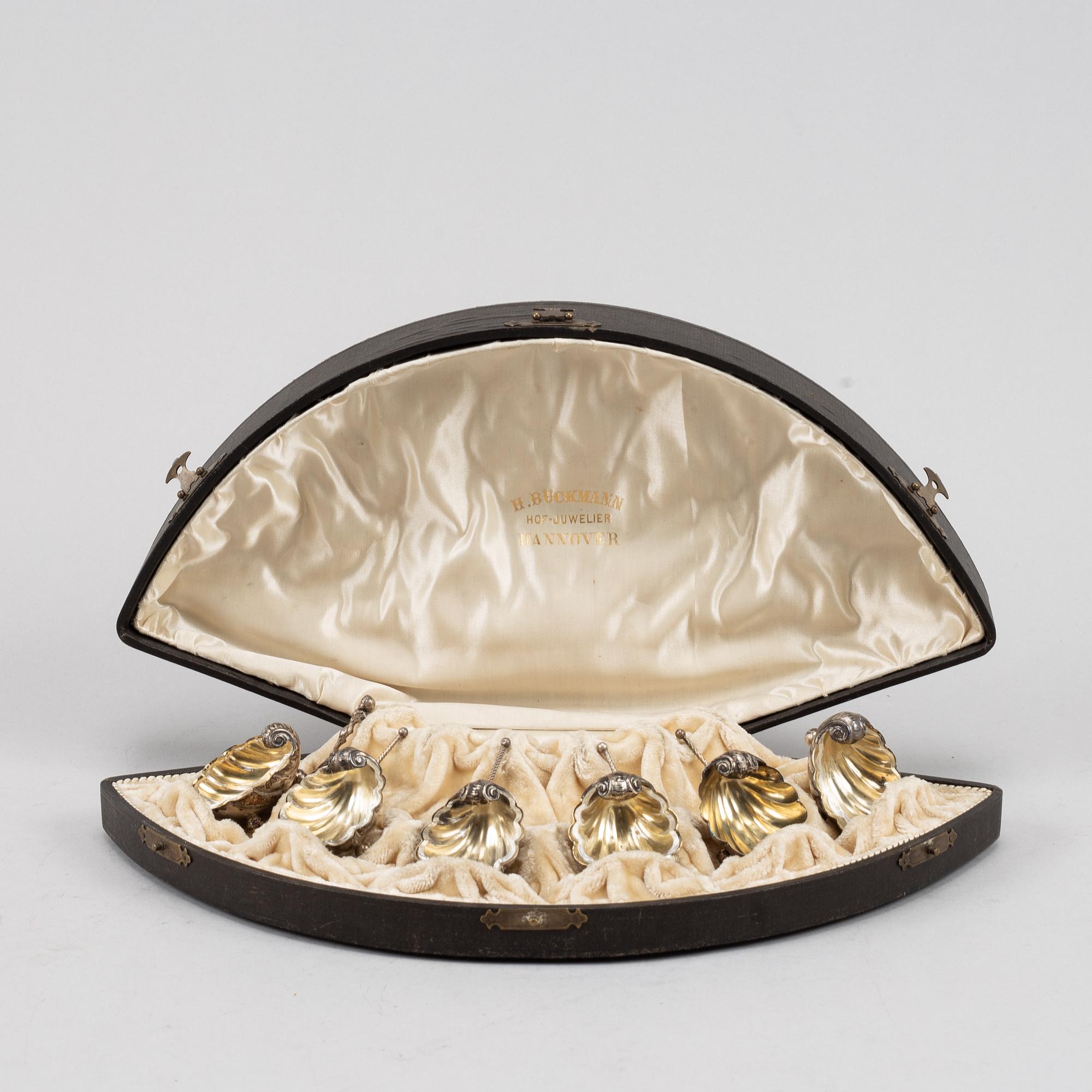 A set of six German parcel-gilt silver 800 salt cellars in fitted case.