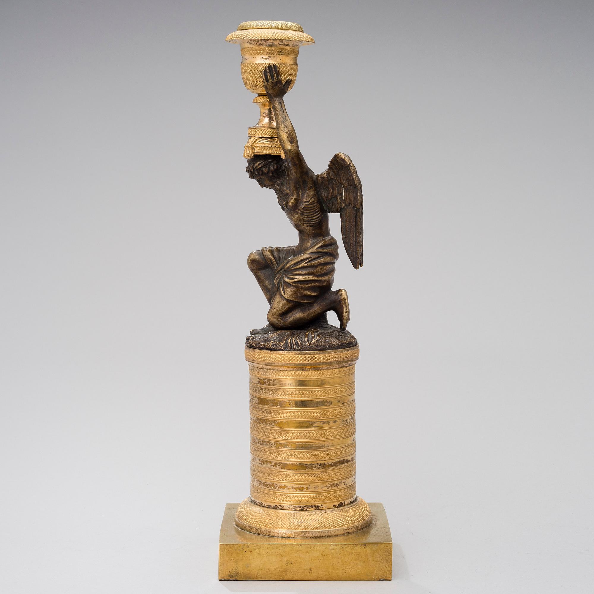A ORMOLU CANDLESTICK, bronze and gilded bronze, empire early 19th century.