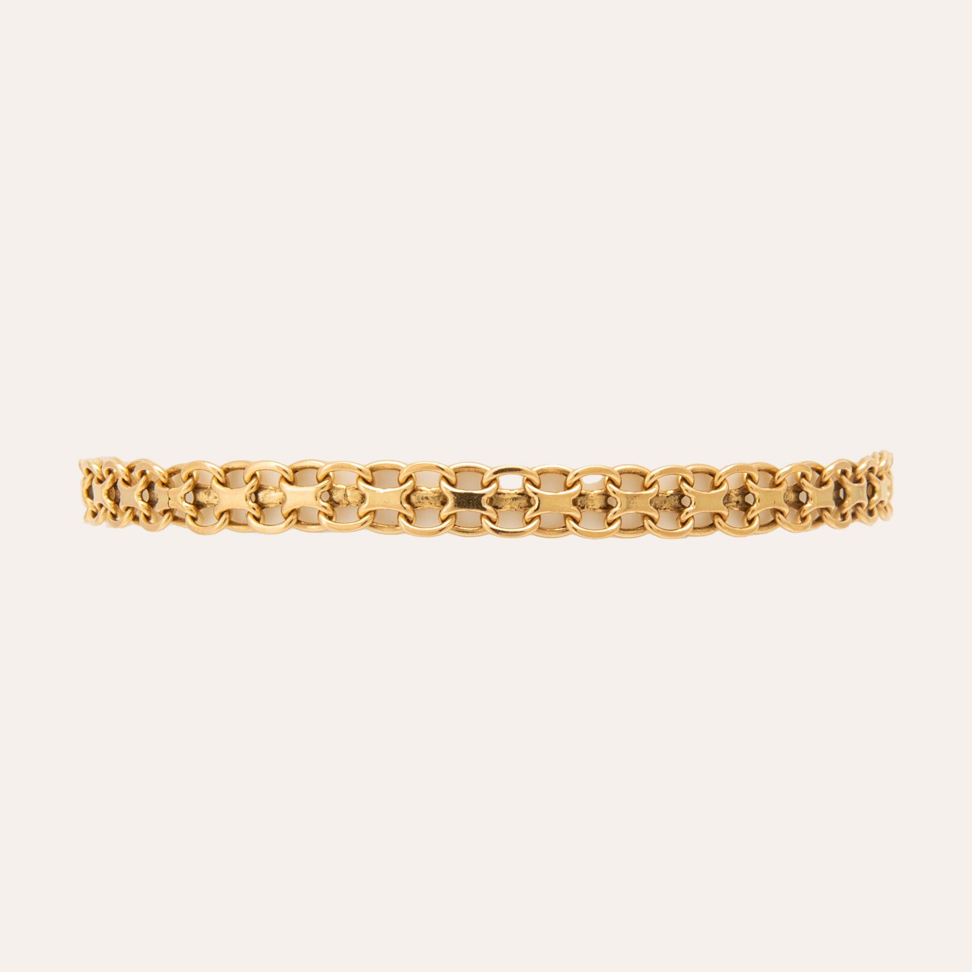 An 18K gold x-link bracelet.