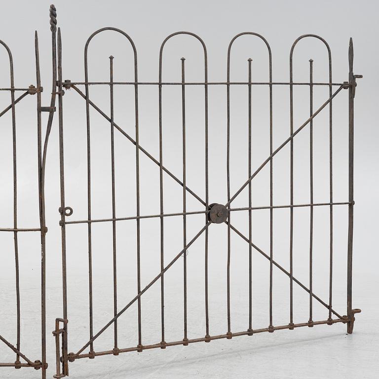 A pair of iron garden gates and a single gate from the early 20th century.