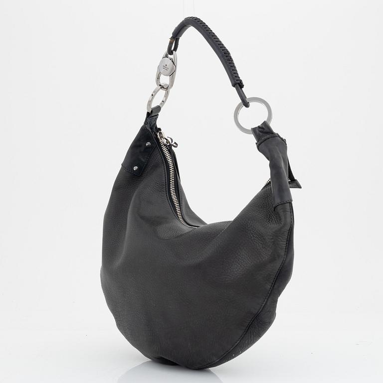 Gucci, a leather bag.