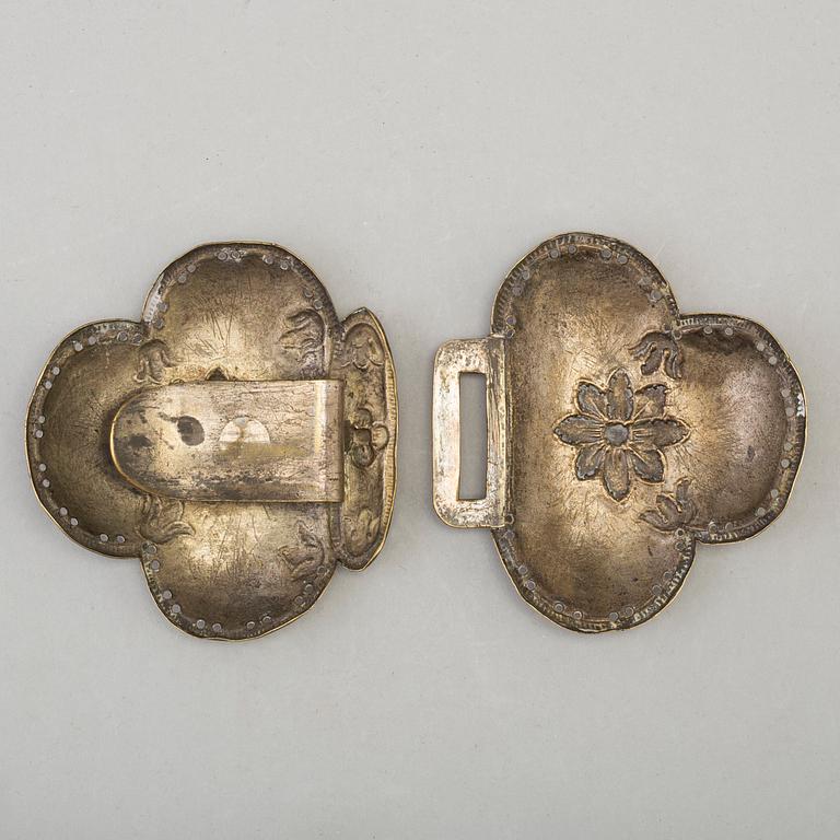 An 18th century brass buckle.