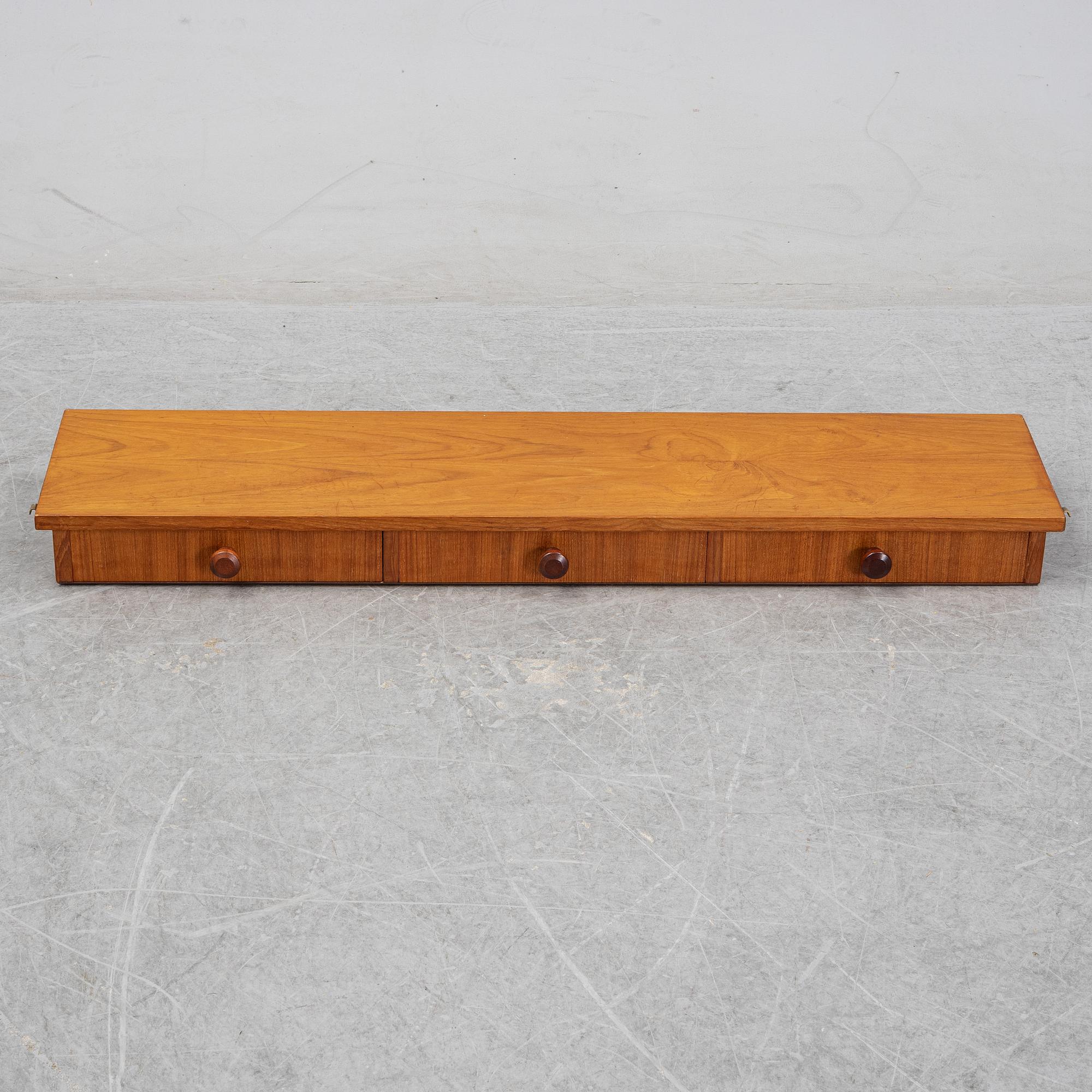 Nils Strinning, A 1950's-60's teak veneered shelf with brackets.