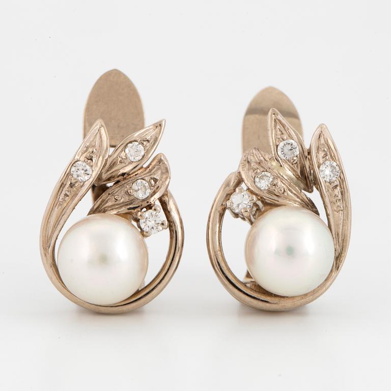 A pair of 18K gold earrings set with cultured pearls ca 7.5 mm.