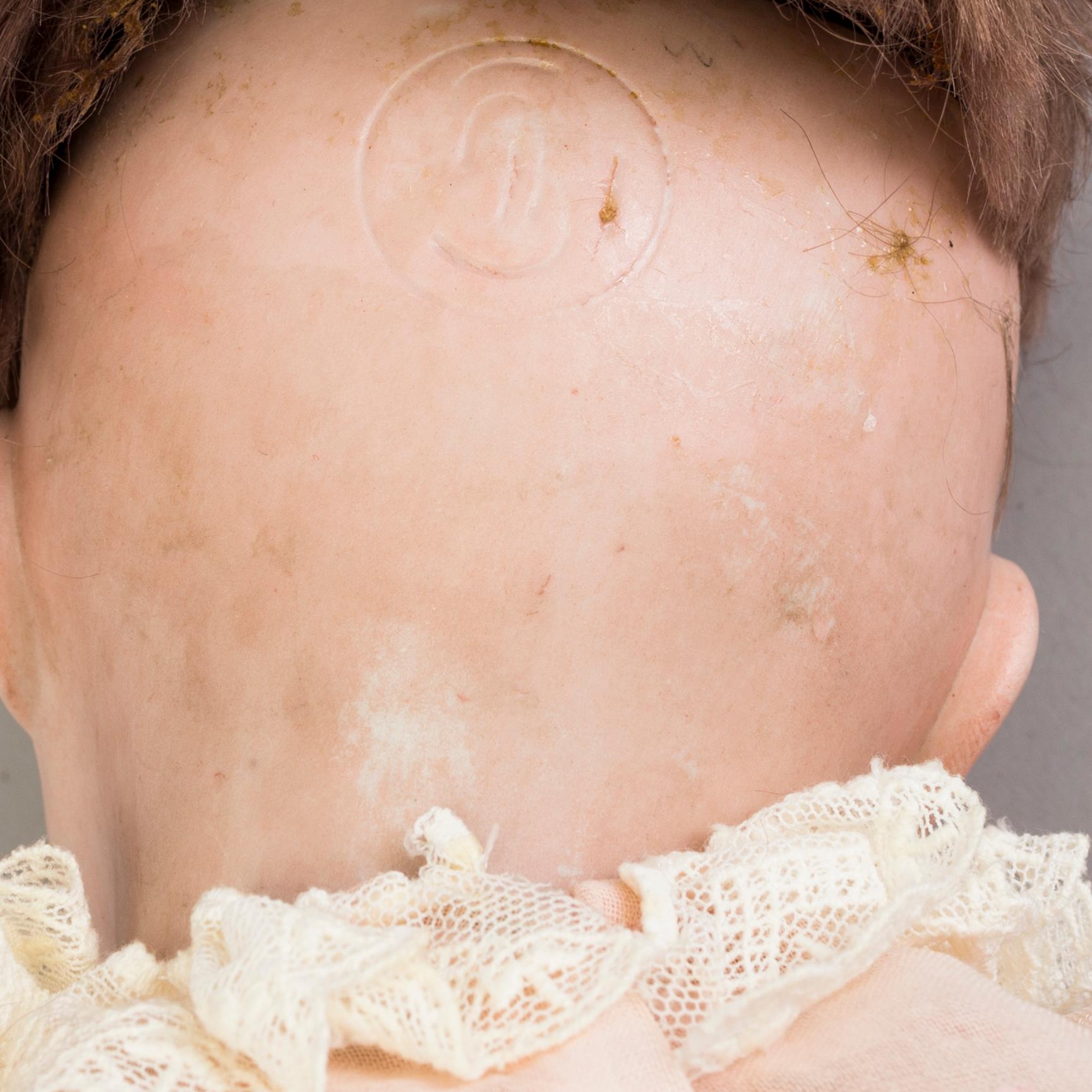 a porcelain doll from the early 20th century.