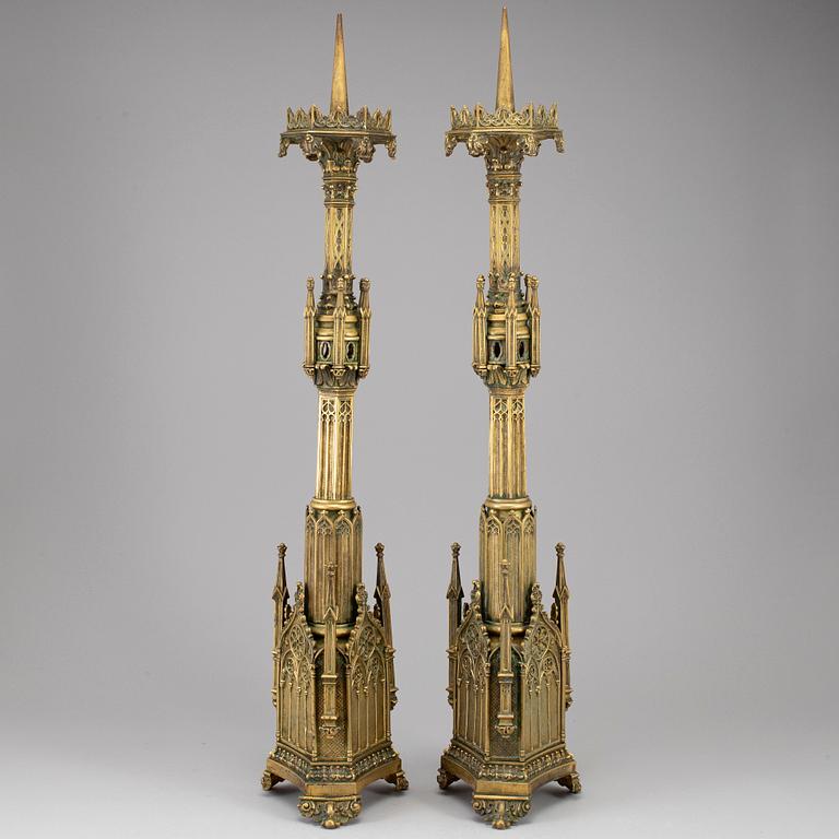 A pair of Pugin style gothic revival candlesticks, mid 19th century.