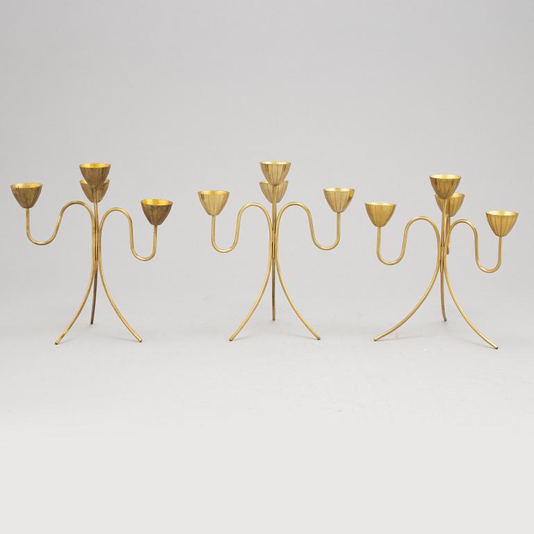 Gunnar Ander, a set of three brass five-light candelabra from Ystad Metall.