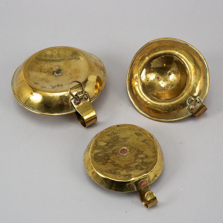 Three 19th century brass night light holders.