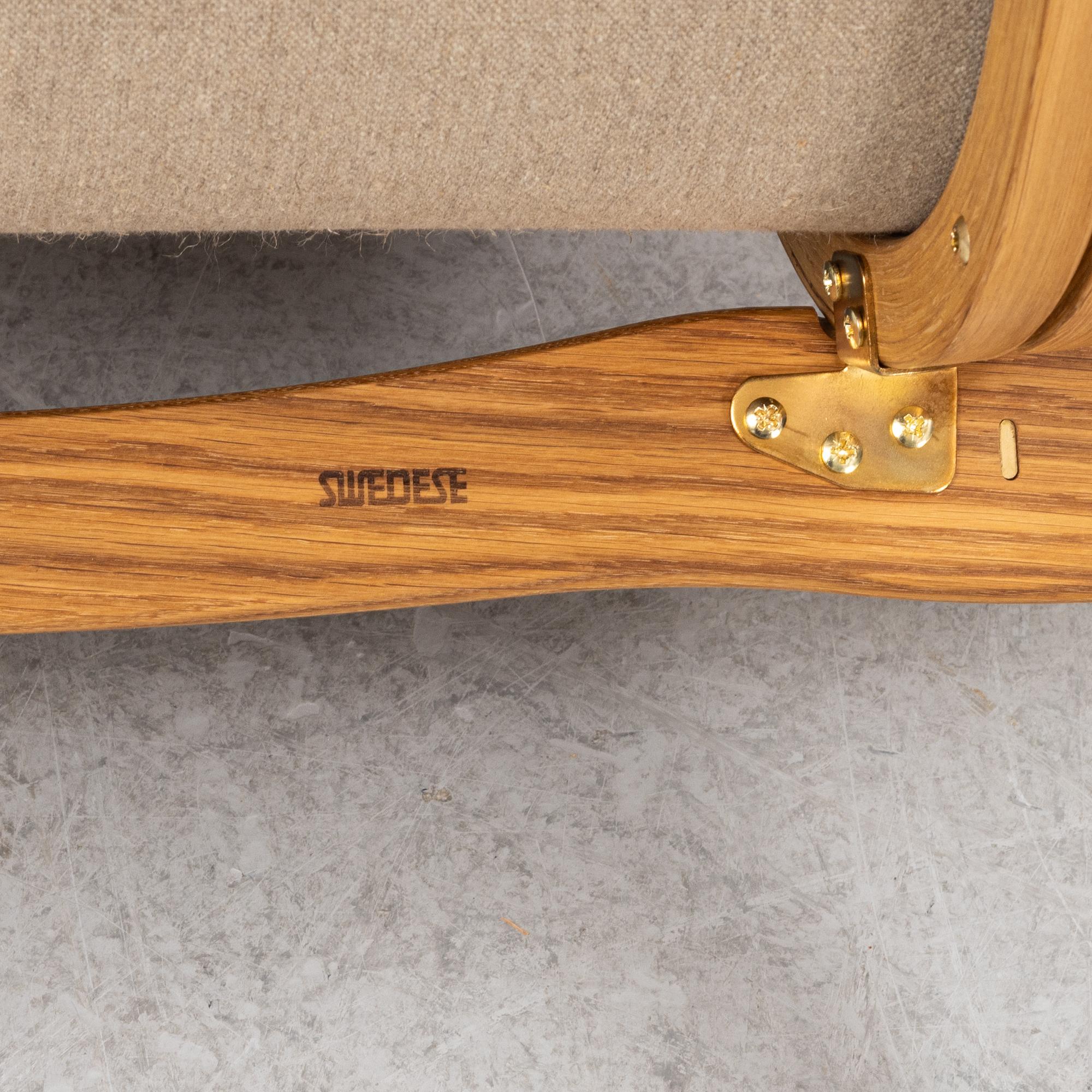 An Yngve Ekström armchair with footstool, "Lamino", Swedese, 21st century.