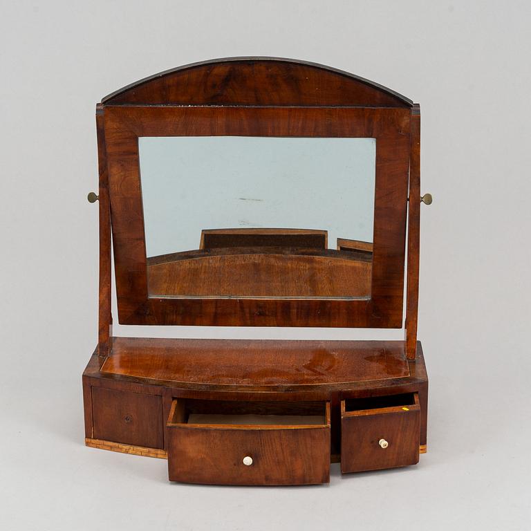 A Swedish Empire mirror with drawer, first half of the 19th century.