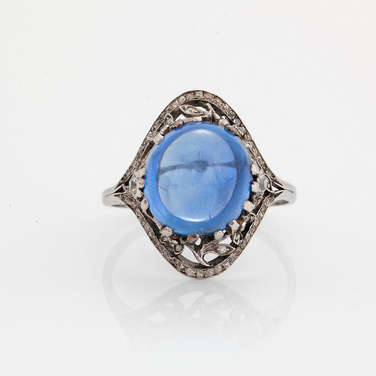 A RING set with a cabochon-cut sapphire.