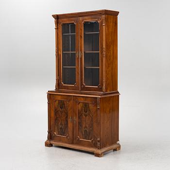 A walnut veneered book cabinet, second part of the 20th Century.