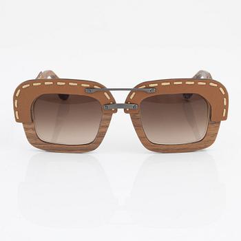 Prada, a pair of wood and leather sunglasses.