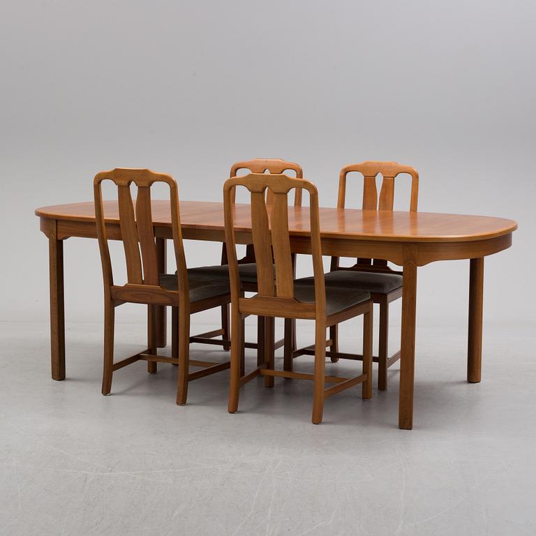 A Carl Malmsten "Ambassadör" dining table and four chairs  , second half of the 20th century. One extension leaf.