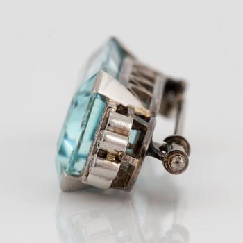 A CF Carlman brooch in 18K white gold set with a faceted aquamarine and eight-cut diamonds.