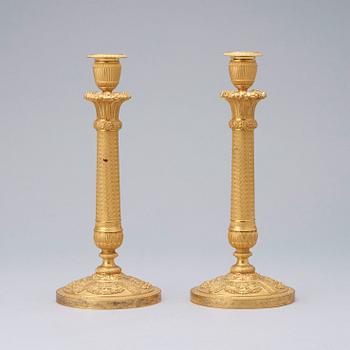 A pair of French Empire early 19th century gilt bronze candlesticks.