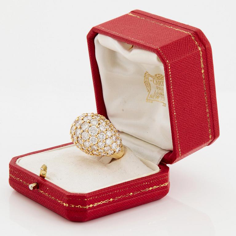 Cartier "Marrakech" an 18K gold bombé ring set with round brilliant-cut diamonds.