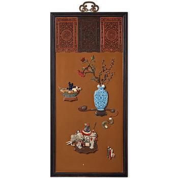 A lacquer wall panel with inlay of stone, cloisonné and porcelain, Qing dynasty, 19th Century.