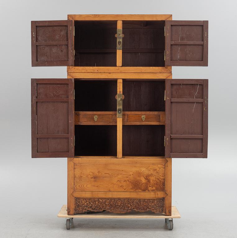 A Chinese hardwood two-part cabinet, 20th century.