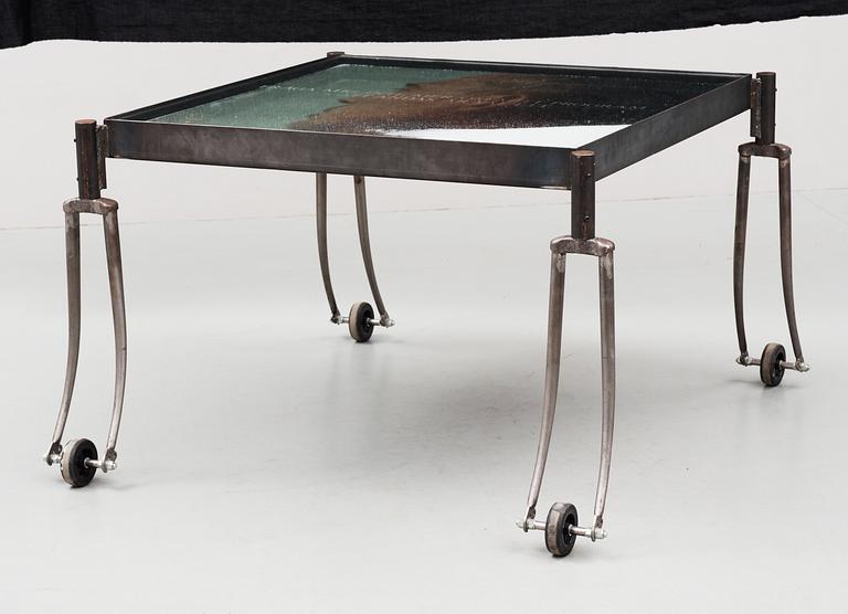 An Alf Linder iron and glass table, decorated with a photo and salt, by Källemo, Värnamo, Sweden 1995.
