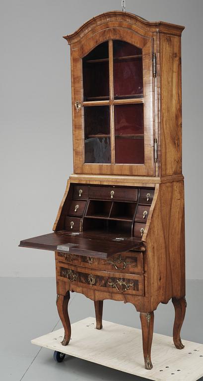 A Rococo walnut writing cupboard.