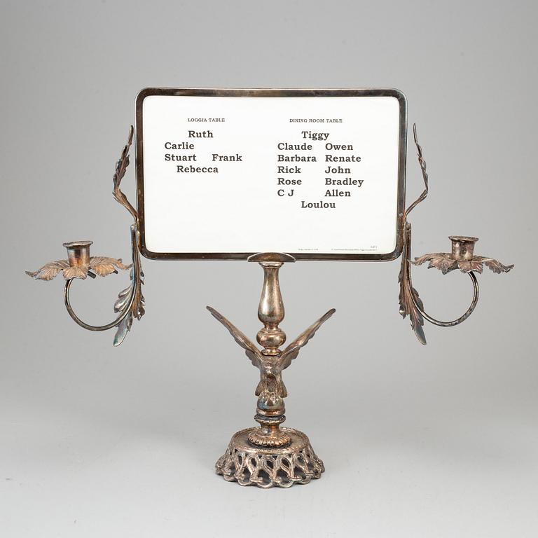 A plated candelabra with table setting card. Rococo-style.