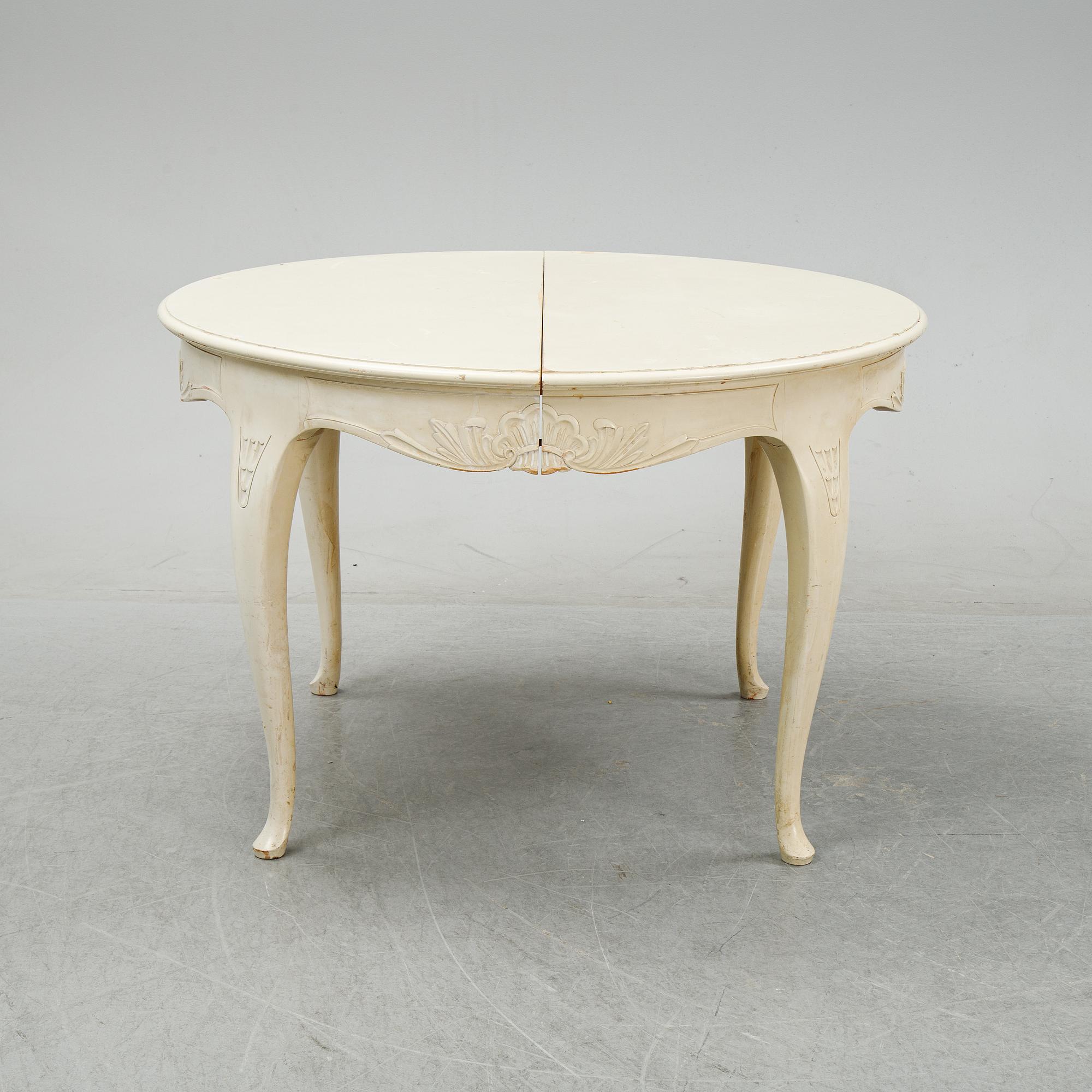 A rococo style dining set with a around table and eight chairs, 20th Century.